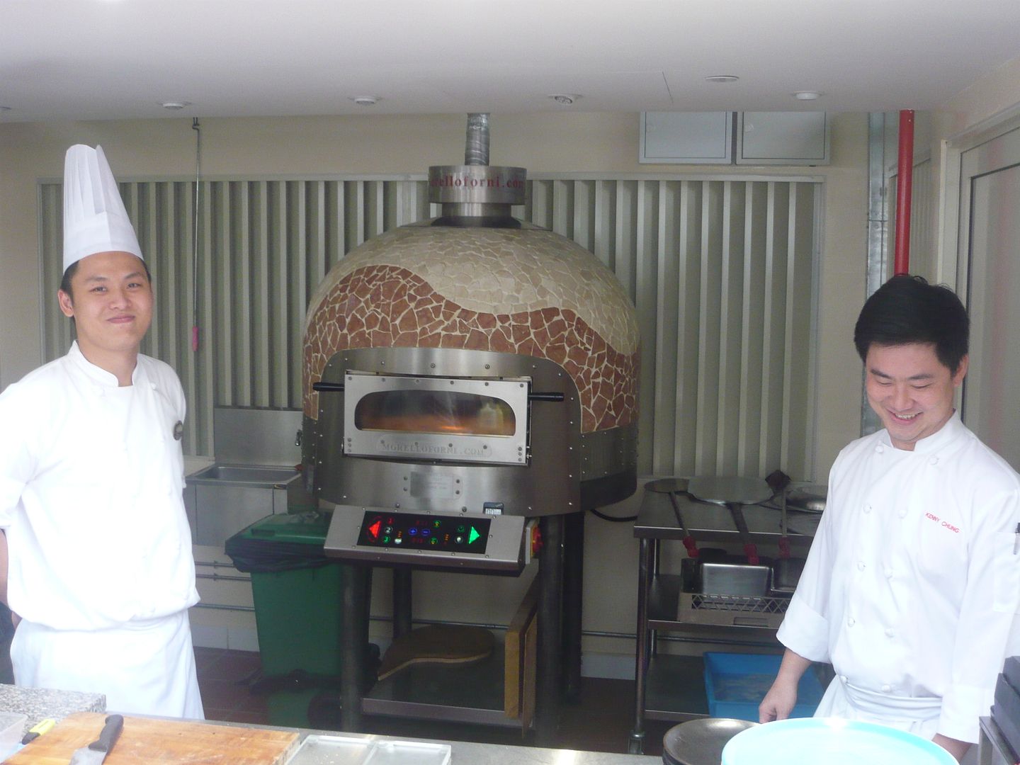 Proud chefs with the pizza oven - where the magic happens