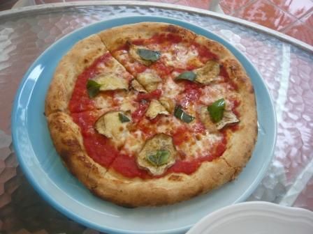 Vegetable pizza with eggplant, fresh basil and mozzarella Raffles Courtyard