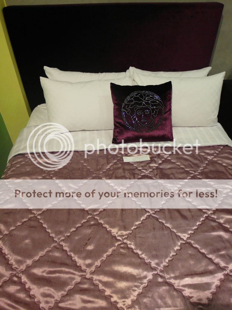  Comfortable and classy quilt cover and bed that faces the cable TV